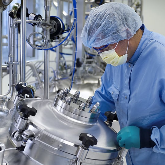 Employee of a pharmaceutical company testing a reactor